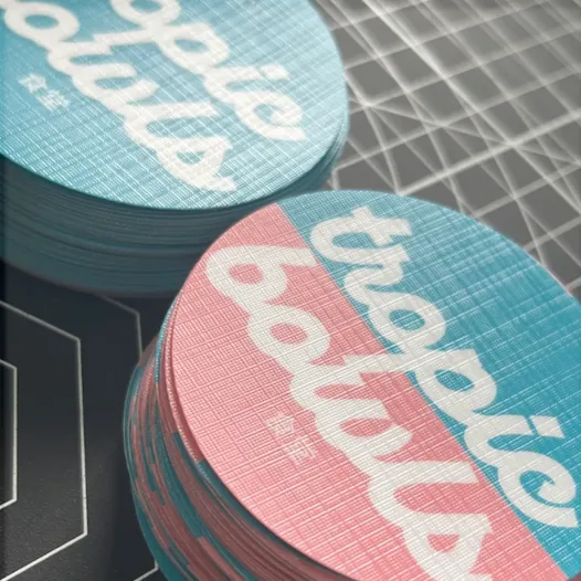 Stacks of round teal and pink stickers with a canvas matte laminate.