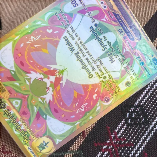Holo rainbow laminate on a printed card, shimmering with a rainbow sheen.