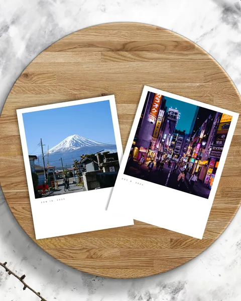 Two photo prints, one of Mount Fuji and one of a neon-lit Tokyo street.