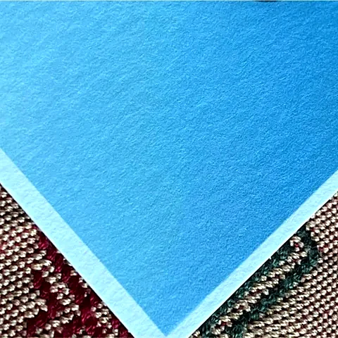 Corner of a photo printed on Astro paper, showing its texture and white edge.