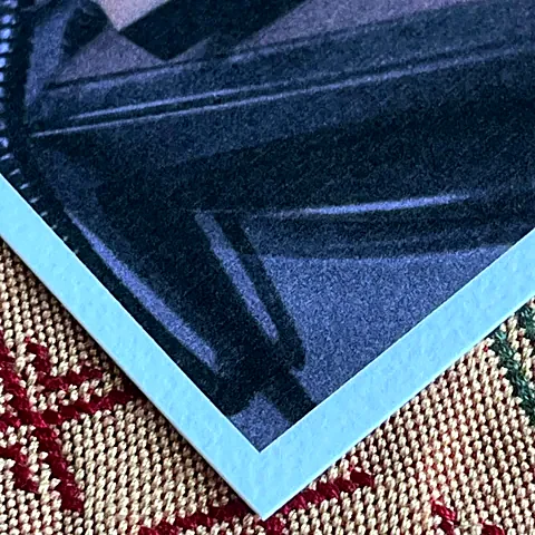 Corner of a photo printed on Granite paper, showing its texture and white edge.