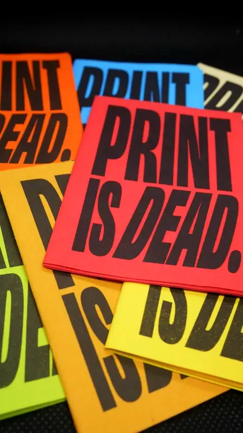 RISO-printed zines with bold black ink on colorful covers