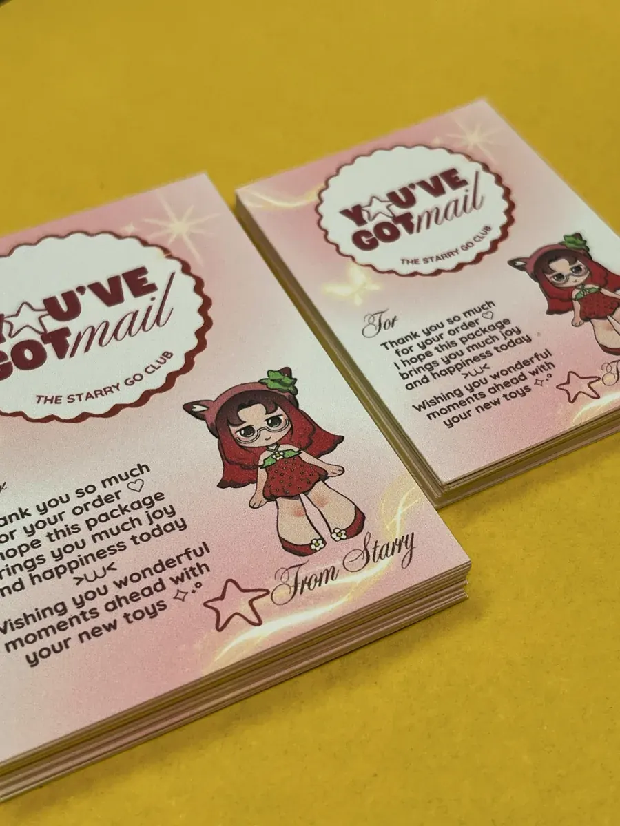 Stack of pink thank-you cards with a cartoon character, on yellow paper
